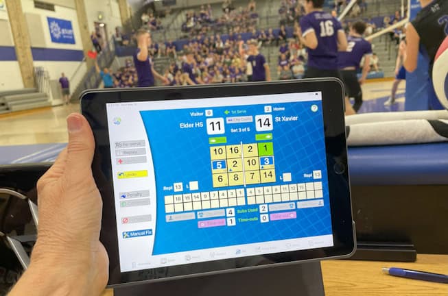 Scorer using VolleyWrite Volleyball Scoring Software on an iPad at a boys high school match